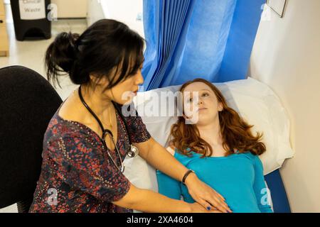 Doctor examining patient in clinic Stock Photo