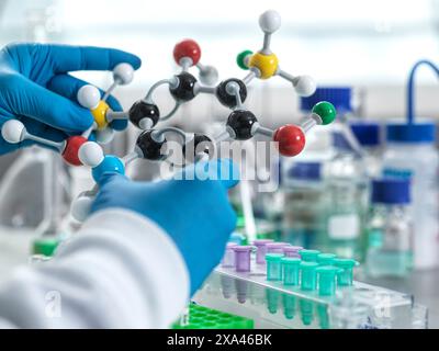 Scientist holding a molecular model in a laboratory setting. Stock Photo