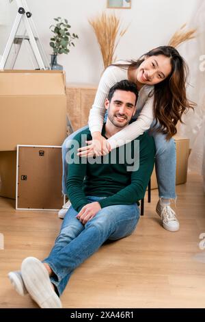 Couple smiling in a room with unpacked boxes Stock Photo