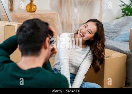 Couple with moving boxes in a cozy room. Stock Photo