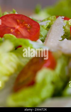 Extreme close up of a mixed salad with tomatoes and parmesan shavings Stock Photo