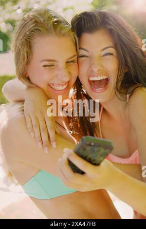 Two Young Women Taking Selfie Laughing Stock Photo