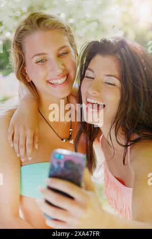 Two Young Women Taking Selfie Laughing Stock Photo