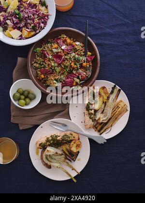 Table top view of gourmet Mediterranean food, including grilled salmon, salad and vegetables Stock Photo