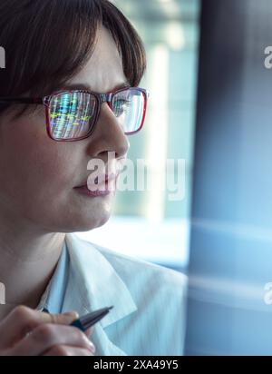 Genomics, Scientist viewing human DNA profiles on screen during testing in the lab Stock Photo