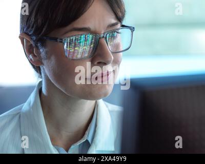 Genomics, Scientist viewing human DNA profiles on screen during testing in the lab Stock Photo