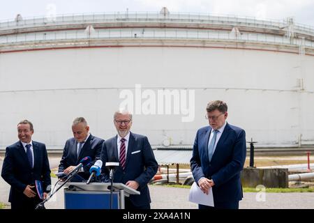 L-R CEO of MERO CR Jaroslav Pantucek, Czech Industry and Trade Minister Jozef Sikela, Prime Minister Petr Fiala and Finance Minister Zbynek Stanjura give the press conference on expansion of Italian TAL pipeline, in Nelahozeves, Czech Republic, on June 4, 2024. Czechia will get rid of its dependence on Russian oil by the middle of next year at the latest, PM Fiala said, adding that he wants to request the end of the exemption on Russian oil imports as soon as the TAL pipeline expansion project is completed. (CTK Photo/Ondrej Deml) Stock Photo