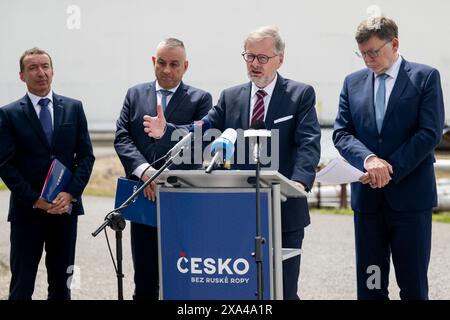 L-R CEO of MERO CR Jaroslav Pantucek, Czech Industry and Trade Minister Jozef Sikela, Prime Minister Petr Fiala and Finance Minister Zbynek Stanjura give the press conference on expansion of Italian TAL pipeline, in Nelahozeves, Czech Republic, on June 4, 2024. Czechia will get rid of its dependence on Russian oil by the middle of next year at the latest, PM Fiala said, adding that he wants to request the end of the exemption on Russian oil imports as soon as the TAL pipeline expansion project is completed. (CTK Photo/Ondrej Deml) Stock Photo