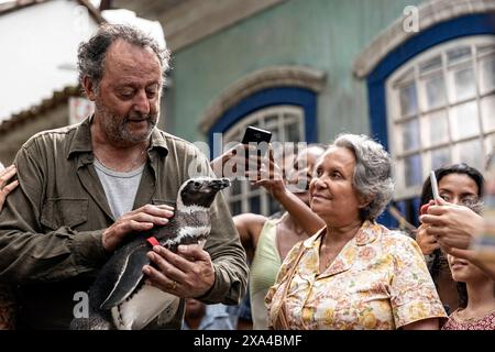 My Penguin Friend (2024) directed by David Schurmann and starring Jean Reno, Adriana Barraza and Rochi Hernández. A lost penguin rescued from an oil spill, transforms the life of a heartbroken fisherman.  Publicity still ***EDITORIAL USE ONLY***. Credit: BFA / Roadside Attractions Stock Photo