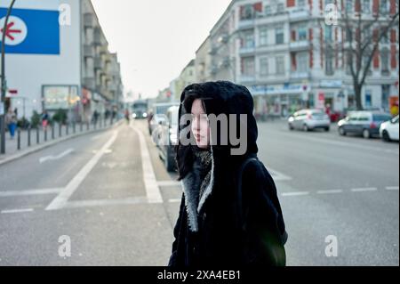 Young woman wearing black fur coat on train Stock Photo - Alamy