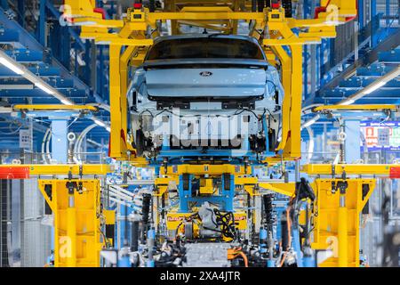 Cologne, Germany. 04th June, 2024. Ford Explorer electric cars stand in the hall at the start of production. It is the first electric car from Ford in Europe. Around two billion euros have been invested in the Cologne production site. Credit: Rolf Vennenbernd/dpa/Alamy Live News Stock Photo