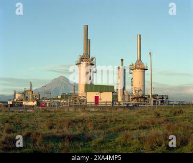 industrial landscape at sunset on farmland with volcanic mountain in the background, New Zealand Stock Photo
