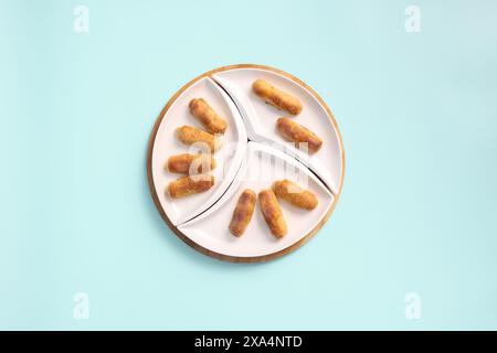 Top View of Sweet Pastries for Tea Time on a White Plate: Croissants, Sweet Rolls Or Twisted Cookies Stock Photo