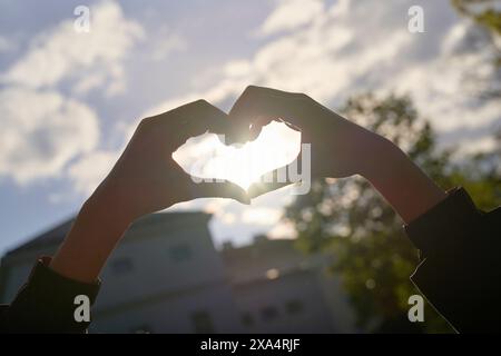 Heart shape hands silhouette against setting sun Stock Photo - Alamy