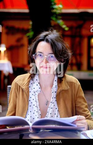 Woman with glasses smiling at a cafe Stock Photo