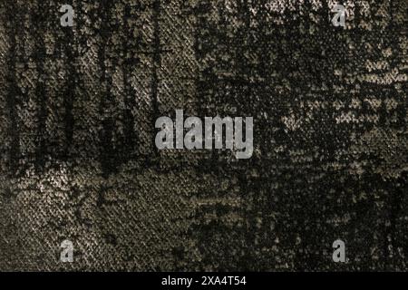 Dark brown fluffy background of soft, fleecy fabric, macro. Texture of umber velveteen textile backdrop with shiny pattern, closeup. Stock Photo