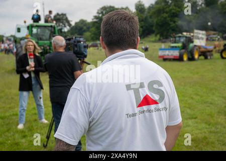 Brussels, Belgium. 04th June, 2024. A Belgian TV crew is seen with a personal security guard during a protest action of various European farmers associations in Brussels, Tuesday 04 June 2024. Farmers take to the streets to demand better conditions to grow, produce and maintain a proper income. BELGA PHOTO JONAS ROOSENS Credit: Belga News Agency/Alamy Live News Stock Photo