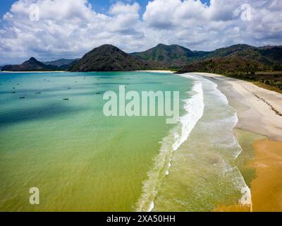 Aerial view of waves breaking onto a sandy tropical beach in Lombok Stock Photo