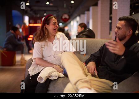 The two friends having a good time, laughing together at a cafe Stock Photo