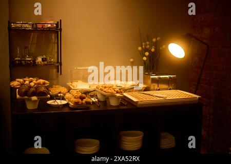 A table set with plates, bowls of food, and a lamp in Madrid, Spain Stock Photo