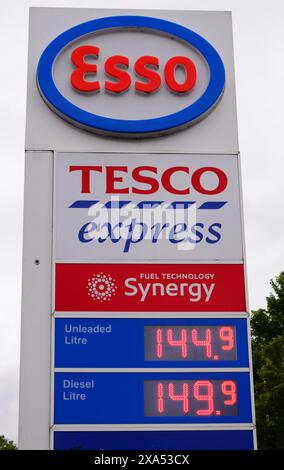 Tesco petrol price sign at a Tesco Express shop or store in Manchester, UK, offers unleaded at 144.9 pence and diesel at 149.9 pence, June 2024 Stock Photo