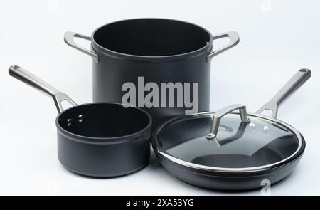 Frying pan and pots set with handles isolated on white studio background Stock Photo