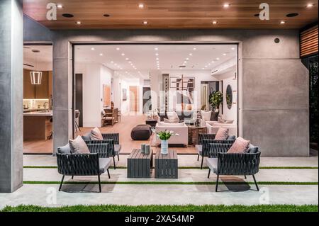 Interior of a house featuring a cozy living room with a couch and chairs Stock Photo