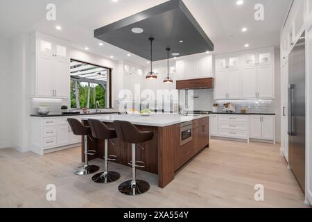 Modern kitchen with two bar stools by a marble countertop Stock Photo