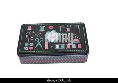 Detail of a small sewing kit on white background. It's a tin box Stock Photo