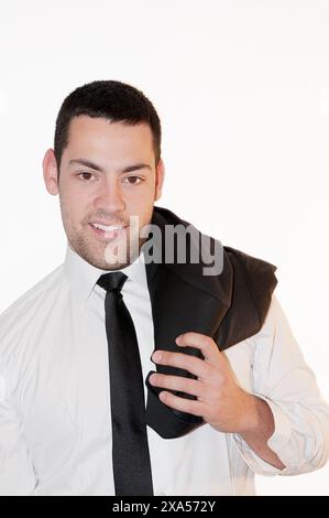 Young man with jacket on his shoulder, smiling and looking at the camera. Stock Photo