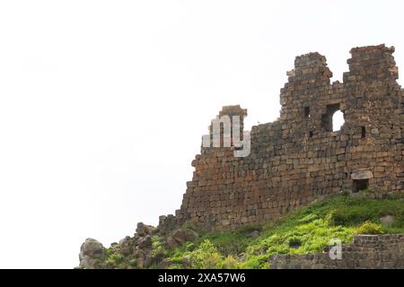 A scenic view of medieval Amberd Fortress on a green hill in Armenia ...