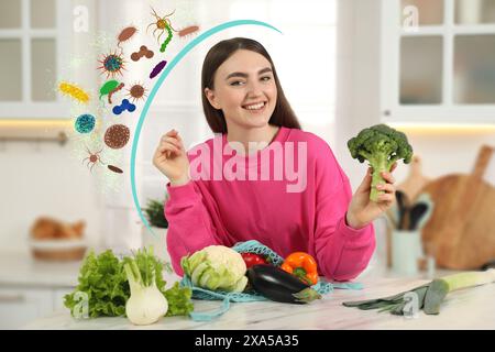 Happy woman with different food products in kitchen. Healthy diet - strong immunity Stock Photo