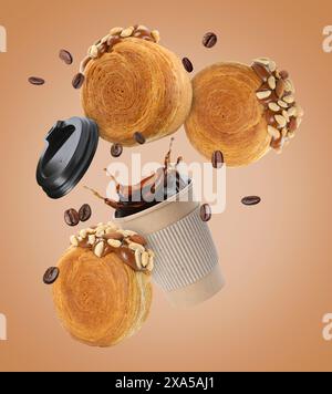 Round croissants and coffee in air on dark beige background Stock Photo