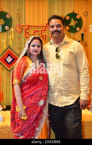 A man and woman in bridal attire posing for a photo in Haldi Ceremony Stock Photo