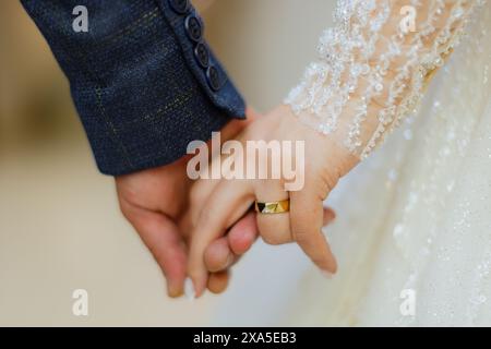 The bride and groom holding hands Stock Photo