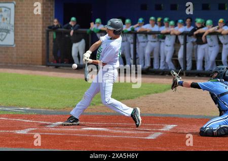 Illinois, USA. Batter making solid contact with a pitch during a high school baseball game. Stock Photo