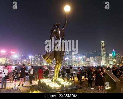 View of The Hong Kong Film Awards statue standing on the Hong Kong Avenue Of Stars on the Kowloon waterfront illuminated at night Stock Photo