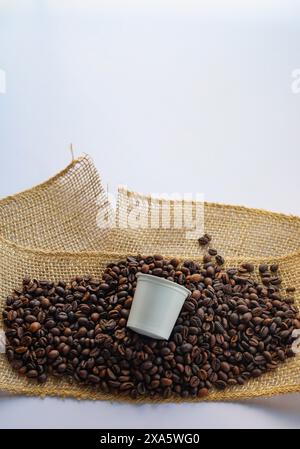 The freshly brewed coffee surrounded by a bed of roasted coffee beans. Stock Photo