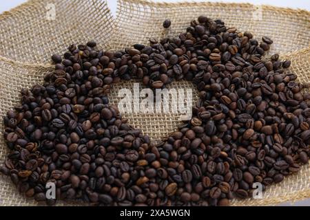 Many coffee beans arranged on a table surface. Stock Photo