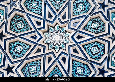 ceramic tile Uzbek mosaic with oriental Arabic Islamic pattern decorated with blue and white floral ornament with stars Stock Photo