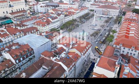 Cityscape with numerous red rooftops and bustling streets below Stock Photo