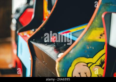 Three arcade games, one with red knobs and another in black color Stock Photo