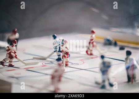 Miniature figurines engaged in a game of table hockey Stock Photo