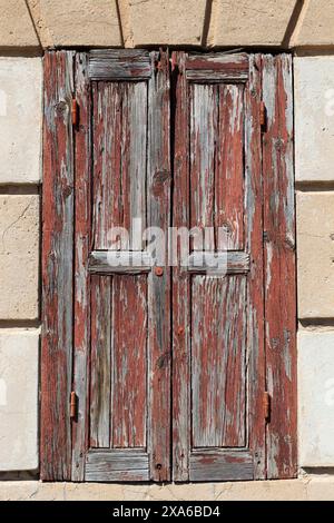 Old wooden door set in stone wall Stock Photo