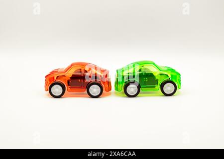 The two toy cars placed side by side on a white background. Stock Photo