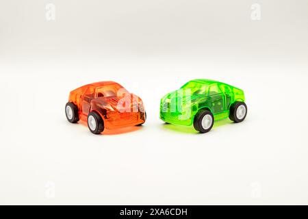 The two toy cars placed side by side on a white background. Stock Photo