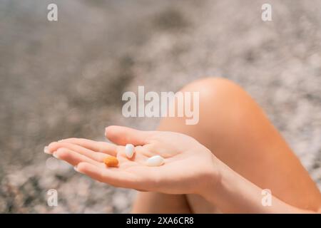 Freelance close up woman hands writing on computer. Well looking middle aged woman typing on laptop keyboard outdoors with beautiful sea view. Stock Photo