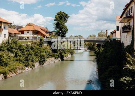 A river and bridge passing through a quaint old town in Skofja Loka, Slovenia Stock Photo