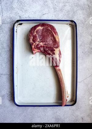 A vertical top view of an uncooked tomahawk steak cut Stock Photo