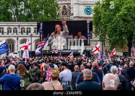 Political Activist Tommy Robinson seen on the big screen giving a ...
